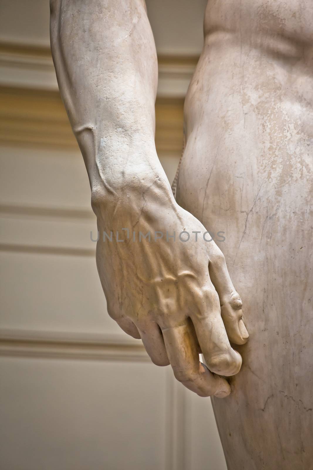 Florence, Tuscany, Italy July 18 2018: Arm detail of Statue of David, completed by Michelangelo Buonarroti in 1504, is one of the most renowned works of the Renaissance, and most famous sculpture in the world. Original statue situated in Florence Accademia in Italy