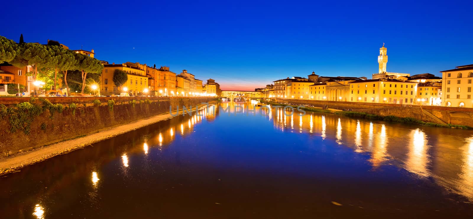 Ponte Vecchio bridge and Arno river waterfront in Florence evening view, Tuscany region of Italy