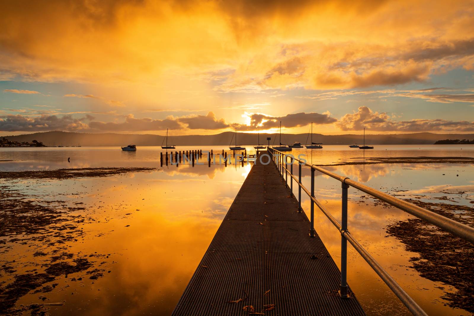 Sunset skies and water reflections from the jetty by lovleah