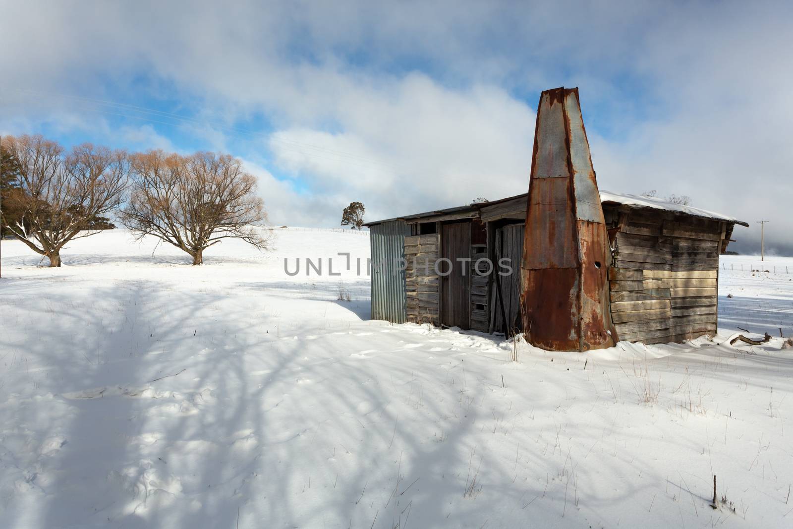 Rustic log shed or stable in rural countryside with full coverag by lovleah