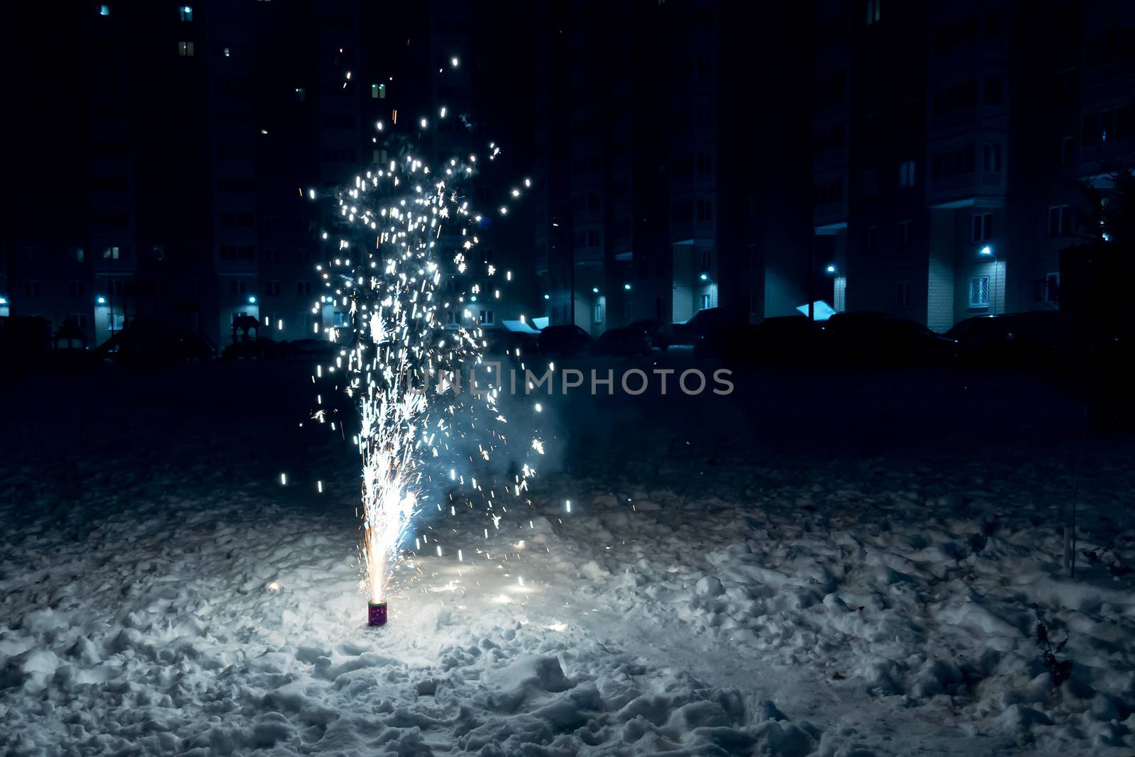 Burning Mini Fireworks in the Snow on a Winter Evening.