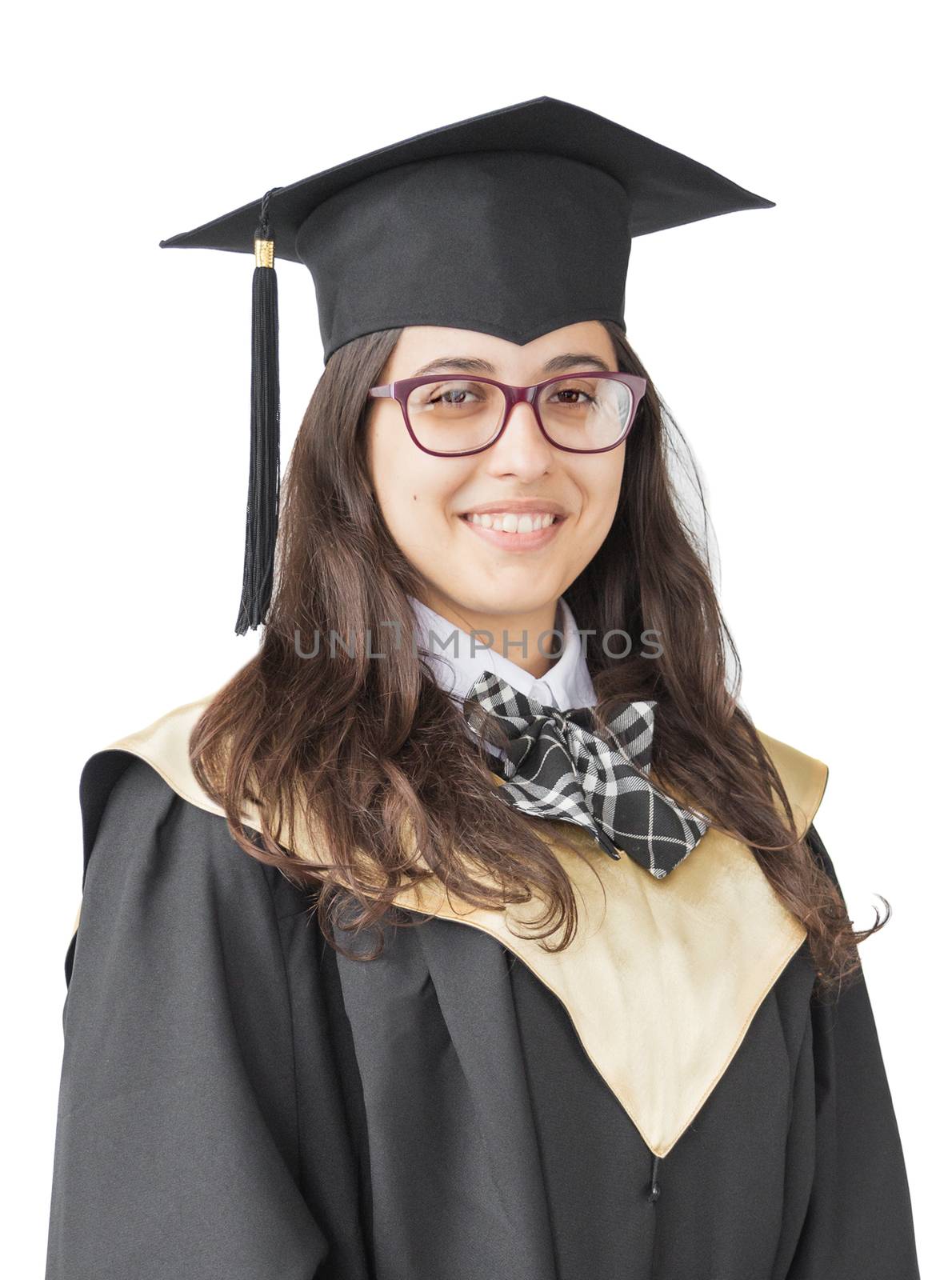 Young girl graduate of the University with eyeglasses, academic cap and black gown, standing isolated on white background