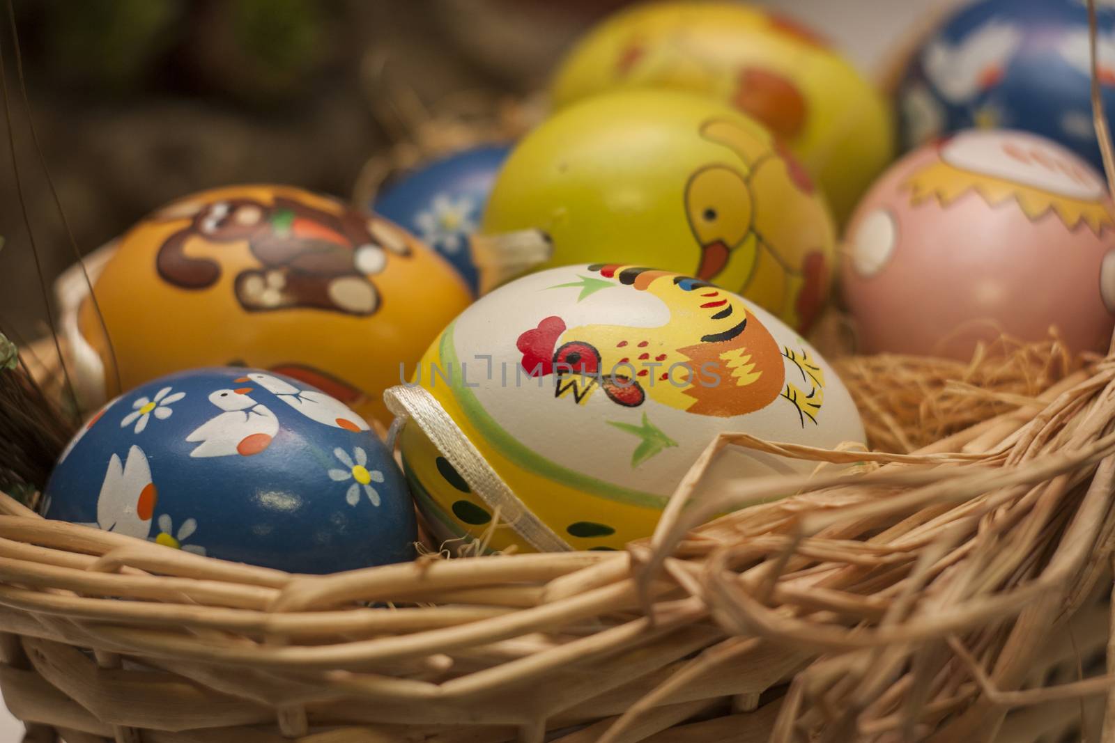 Easter colored eggs in a wicker basket. An Easter Symbol.
