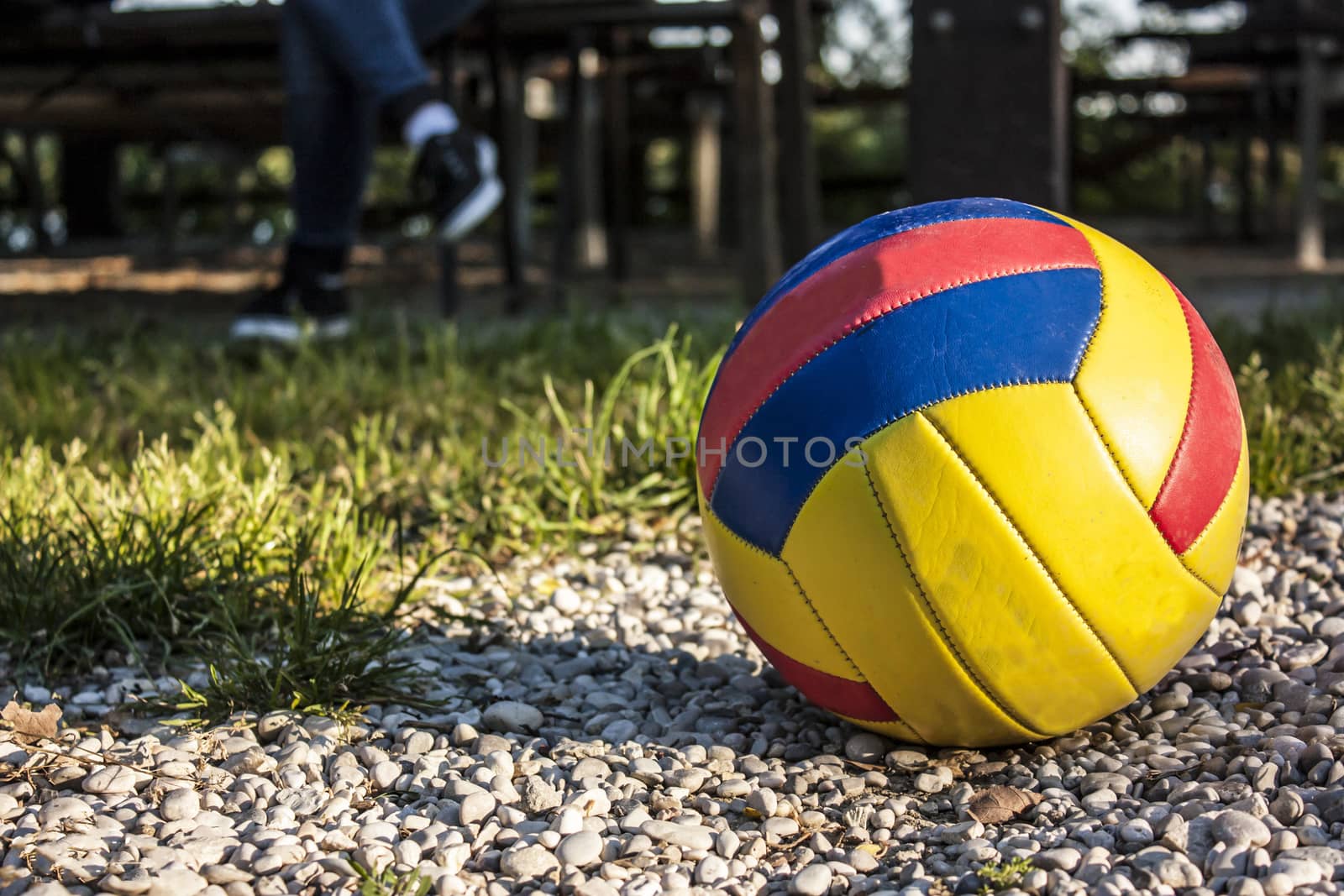 Volleyball and legs of a paused player. The fun of sports and outdoor play.