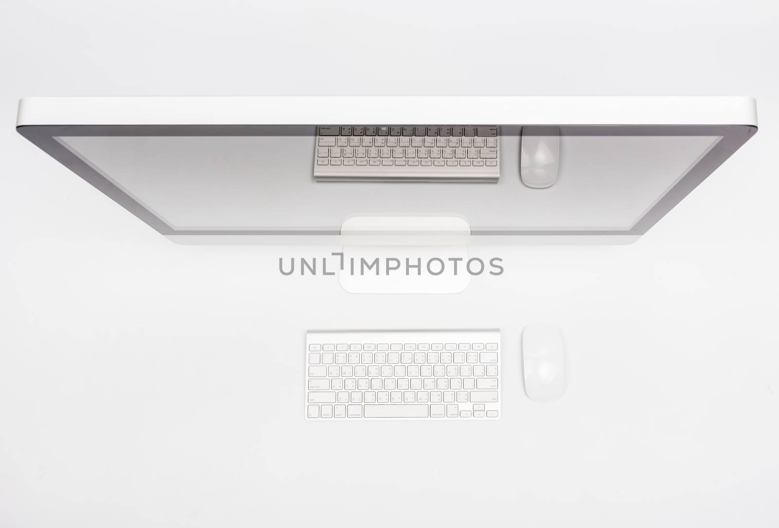 Top view monitor computer retina display, mouse, keyboard and blank screen on white table
