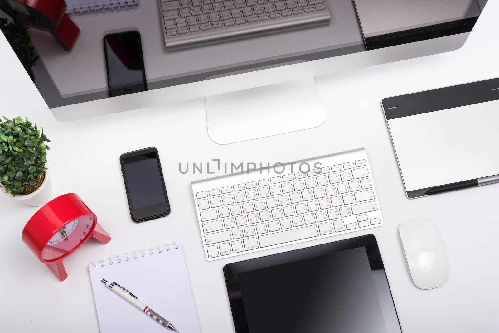 Top view Office monitor computer retina display, mouse, keyboard, mobile phone, tablet and blank screen on white table