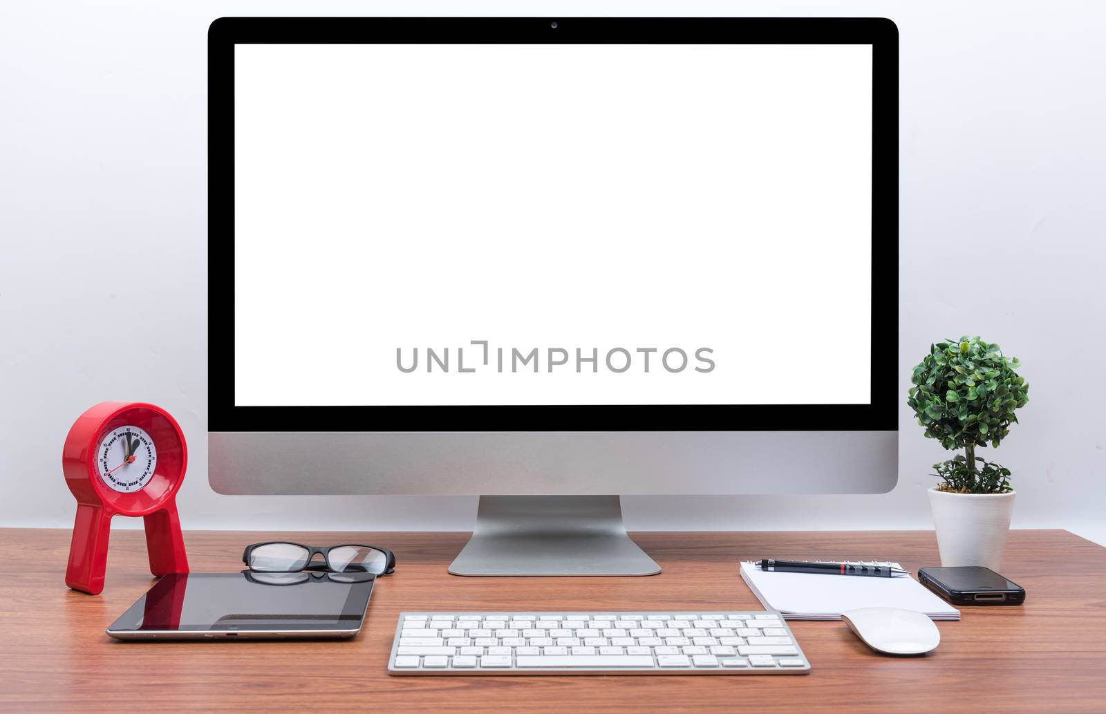 Office Monitor computer PC, keyboard, Mobile Phone, magic mouse and tablet on wooden desk
