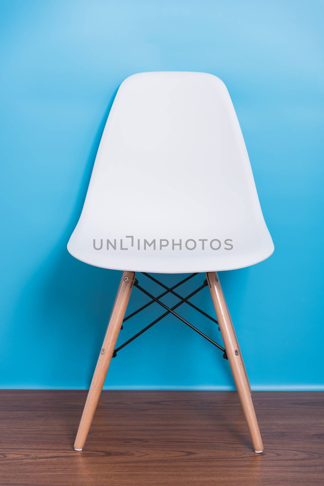 Modern white chair nobody in blue room background