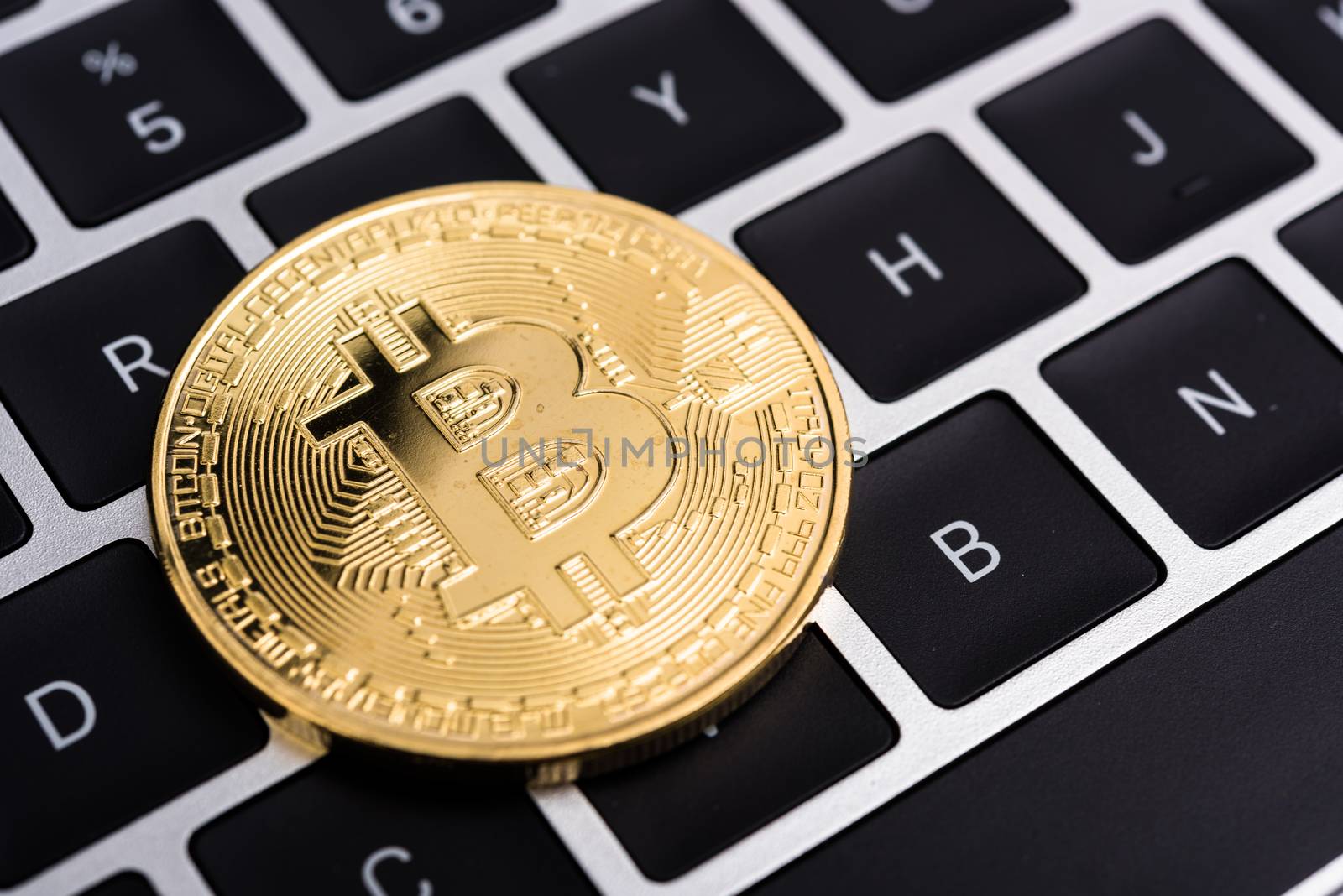 Coin, virtual golden bitcoin money on keyboard laptop computer,  by Sorapop