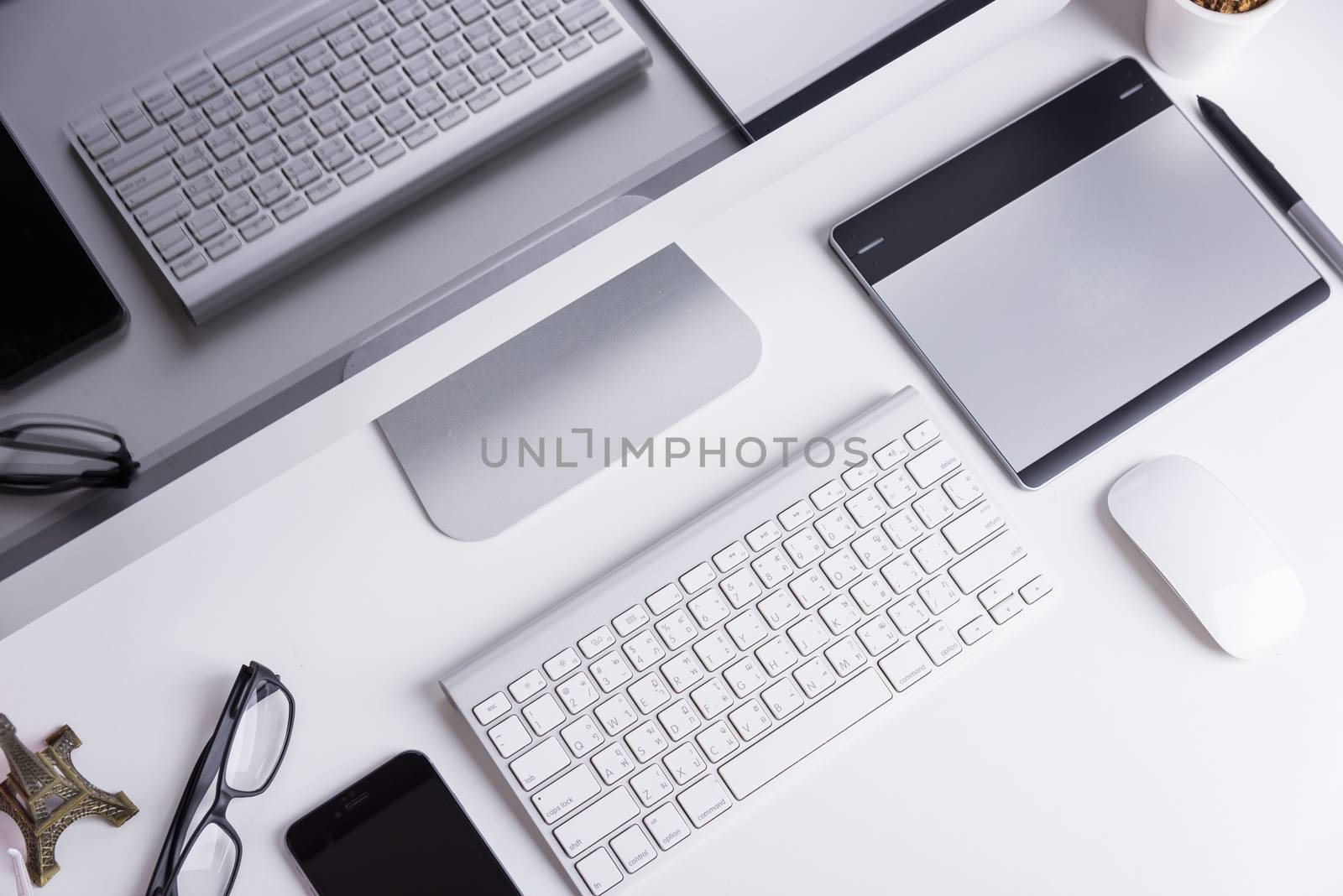 Office Computer on white wooden table and mobile phone