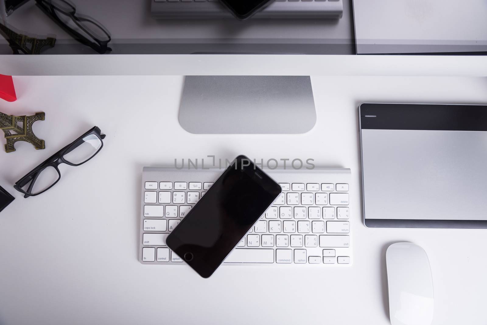 Office Computer on white wooden table and mobile phone