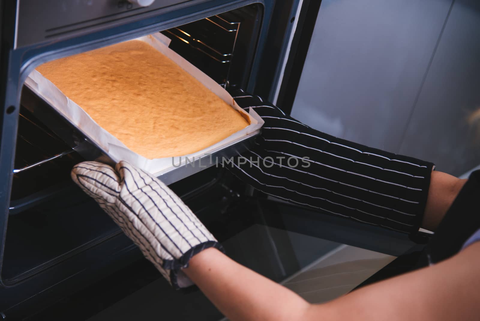 Hands of baker woman holding dough bread bakery cake fresh on front oven