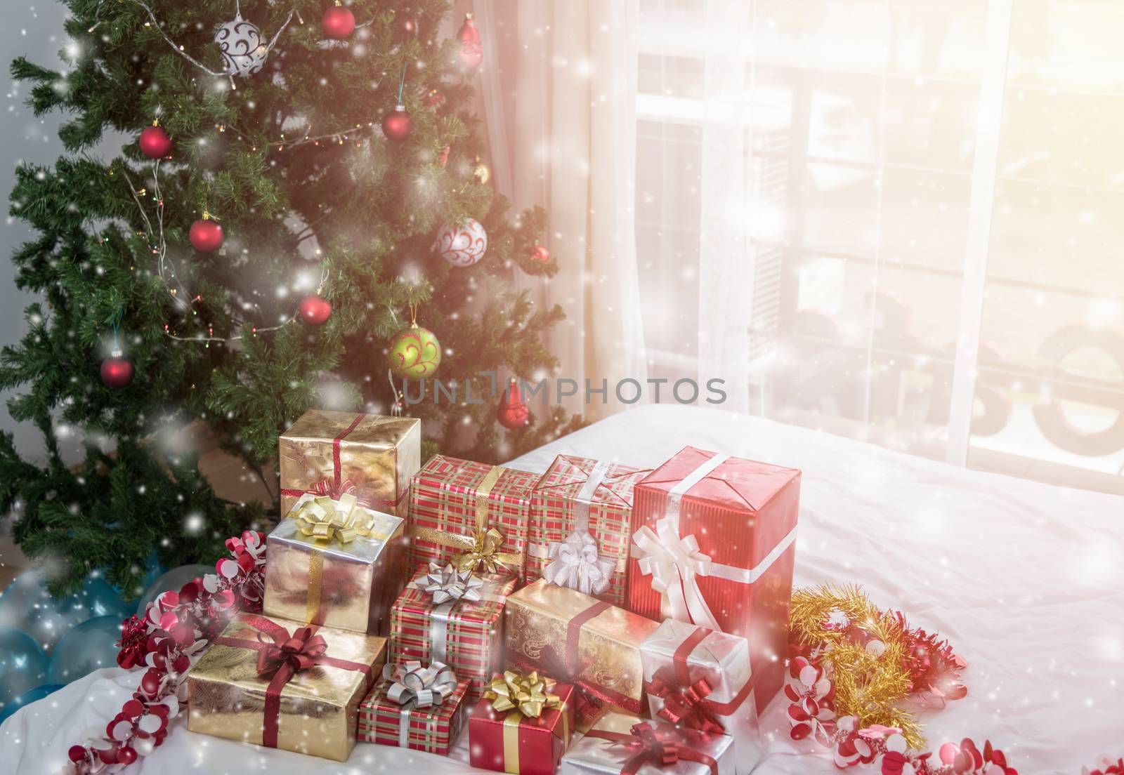 Many Christmas presents gift boxes on a table with Christmas tree, holidays, presents, new year and celebration concept