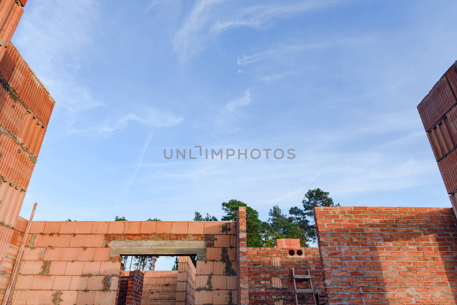 Interior of a Unfinished Red Brick House Walls under Construction without Roofing.