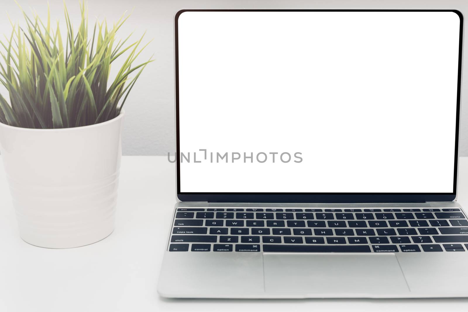 Laptop computer blank screen on white desk in office home