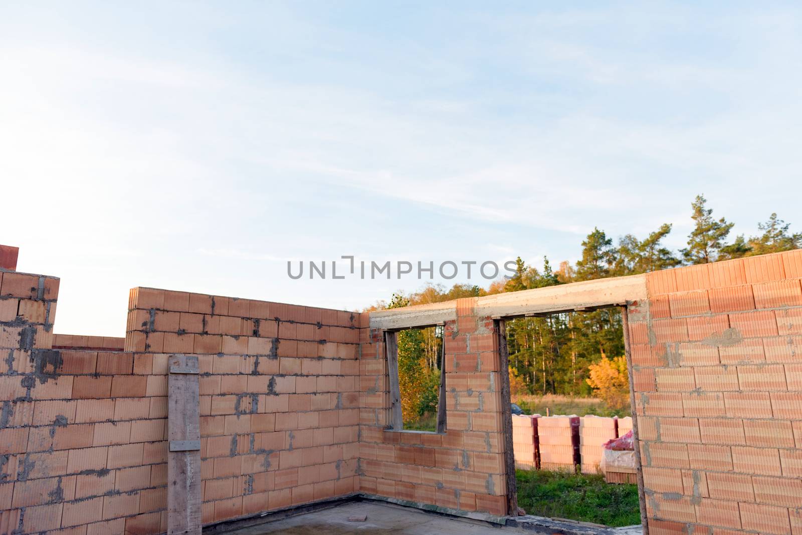 Interior of a Unfinished Red Brick House Walls under Construction without Roofing.