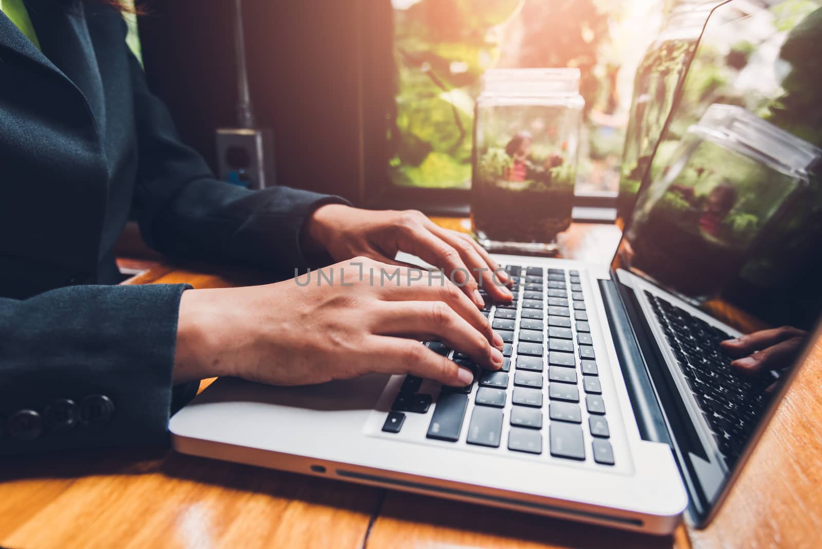 Young businesswoman is working by typing on his computer laptop  by Sorapop