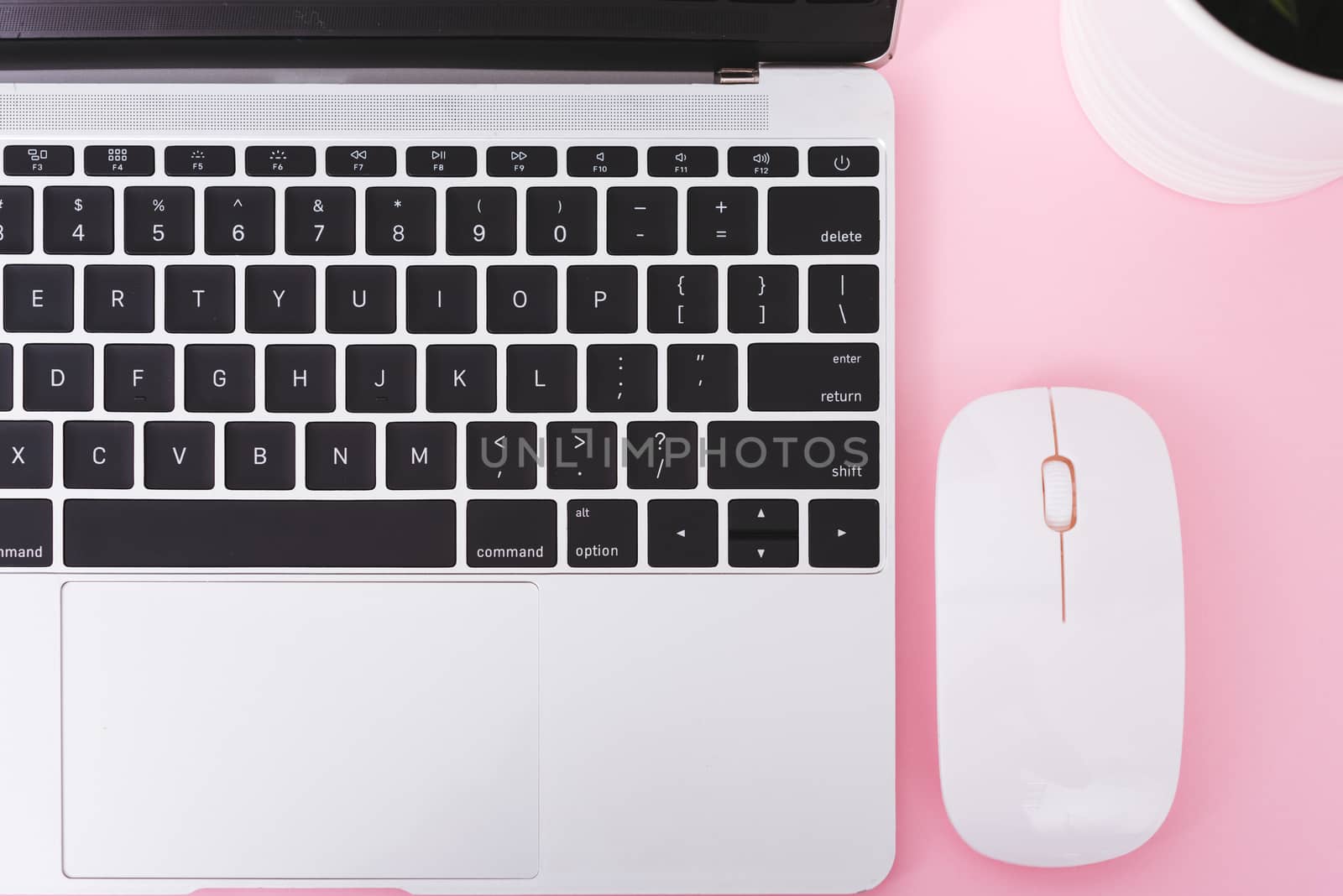 Top view laptop computer notebook and wireless mouse isolated on pink background