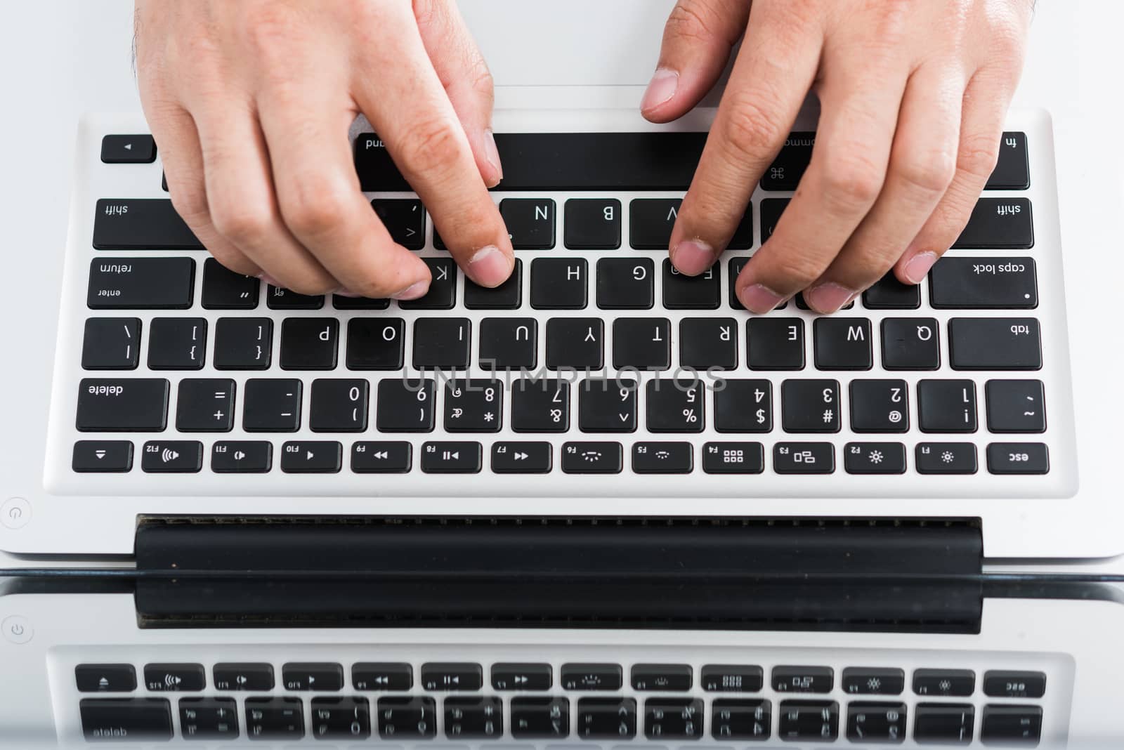 Hand typing on laptop keyboard by Sorapop