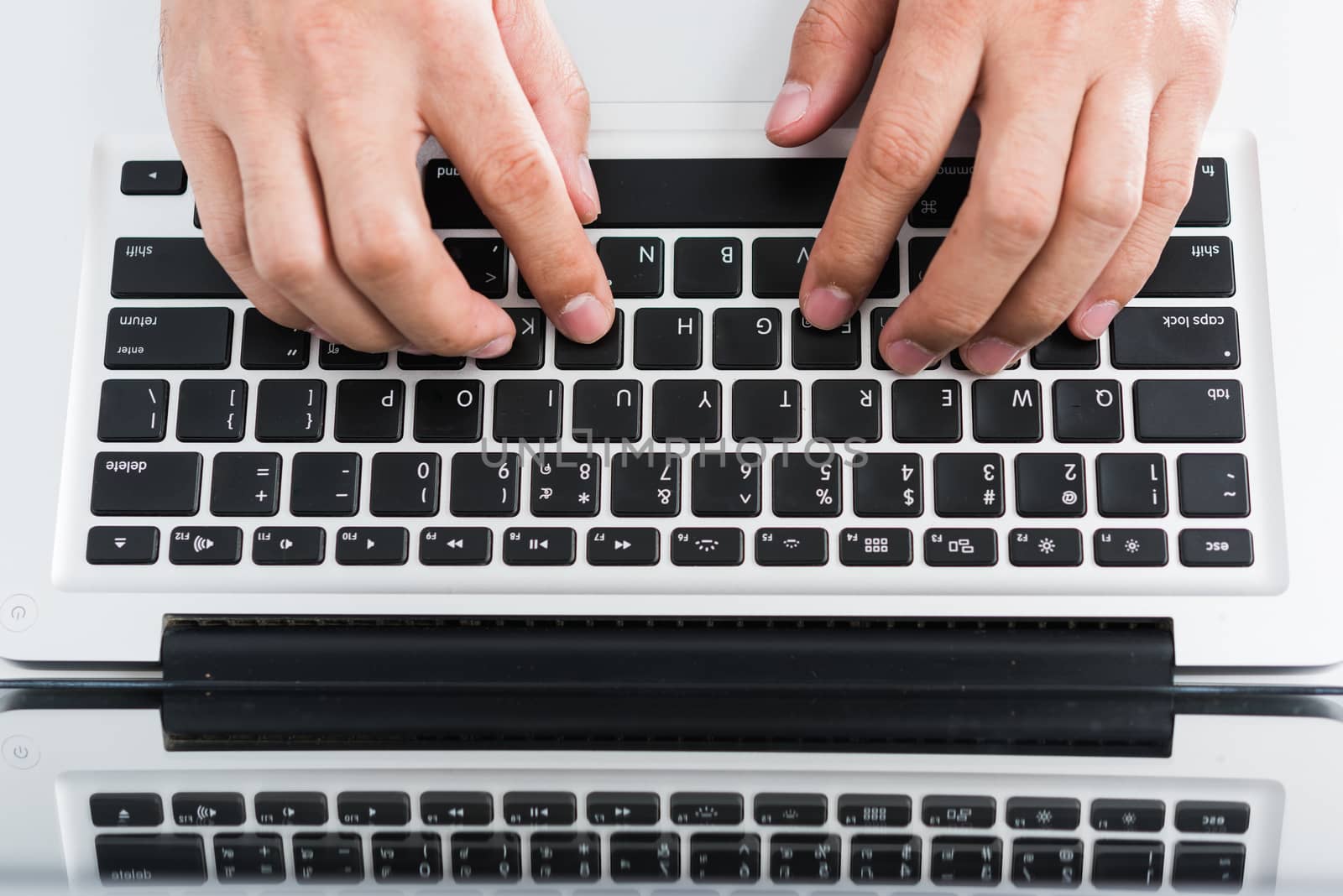 Hand typing on laptop keyboard picture from a high angle