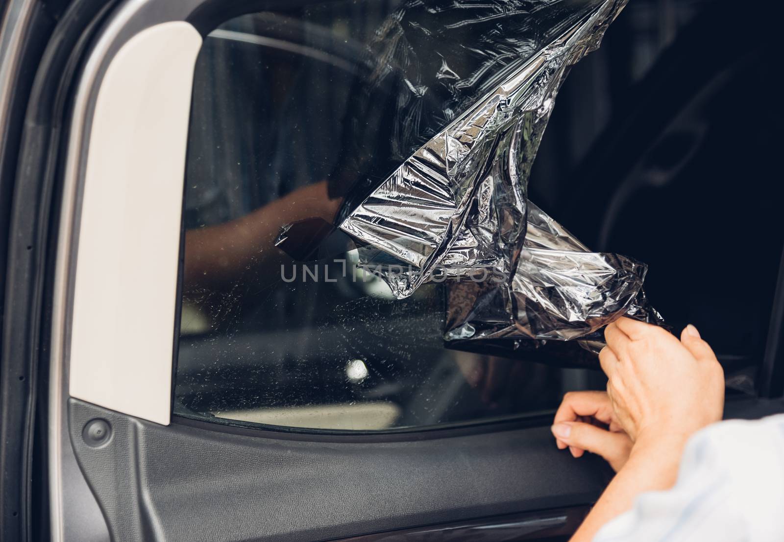Specialist worker service peeling old film from window car