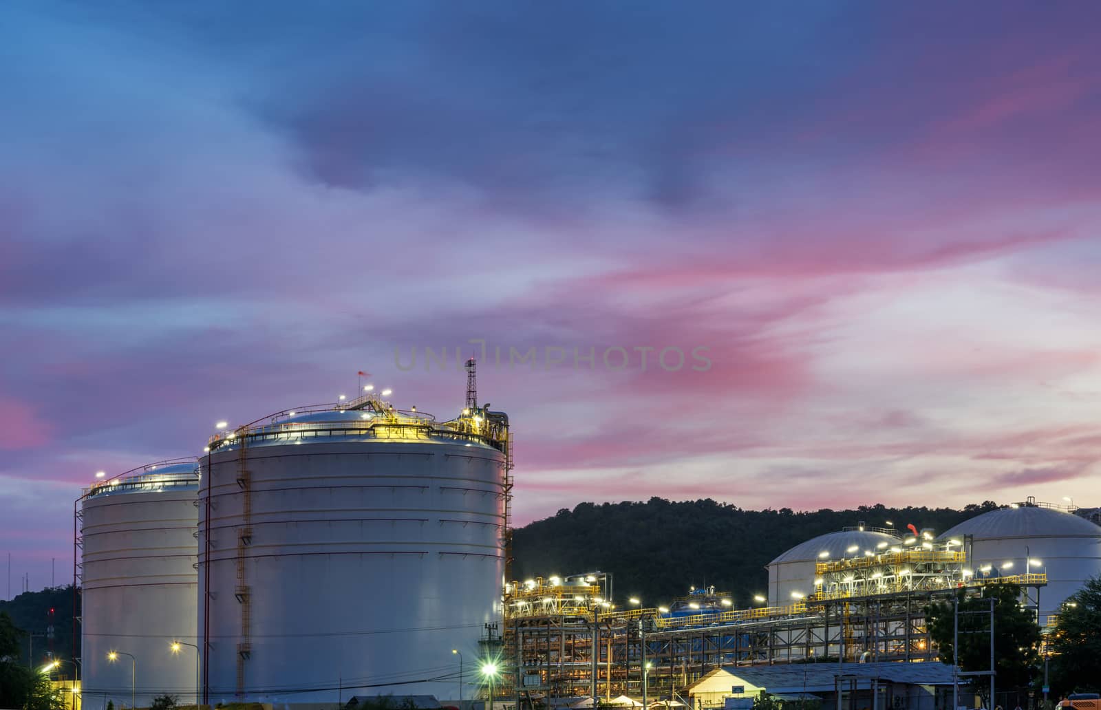Oil petrochemical refinery plant at sunset twilight
