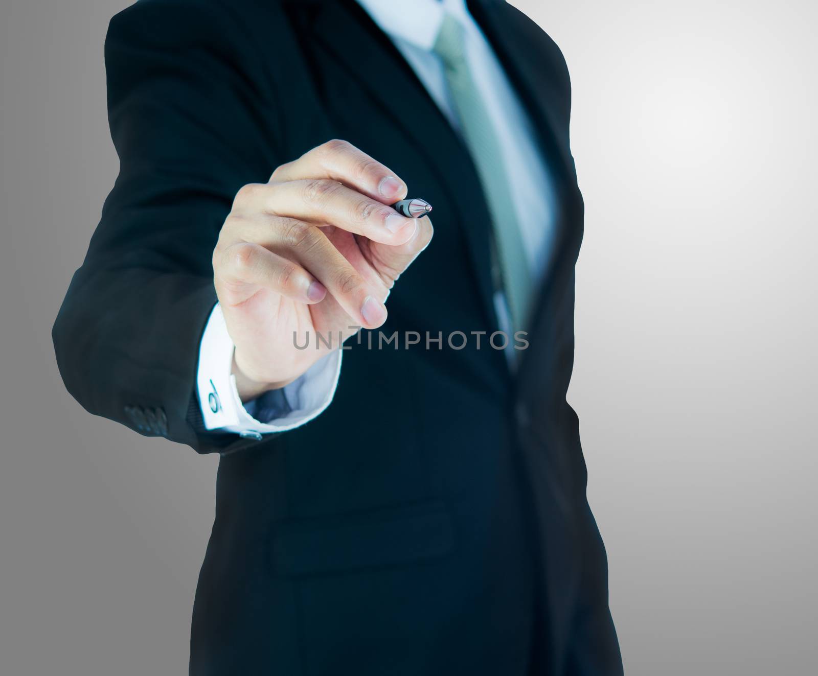 Businessman standing posture hand hold a pen isolated on over gray background