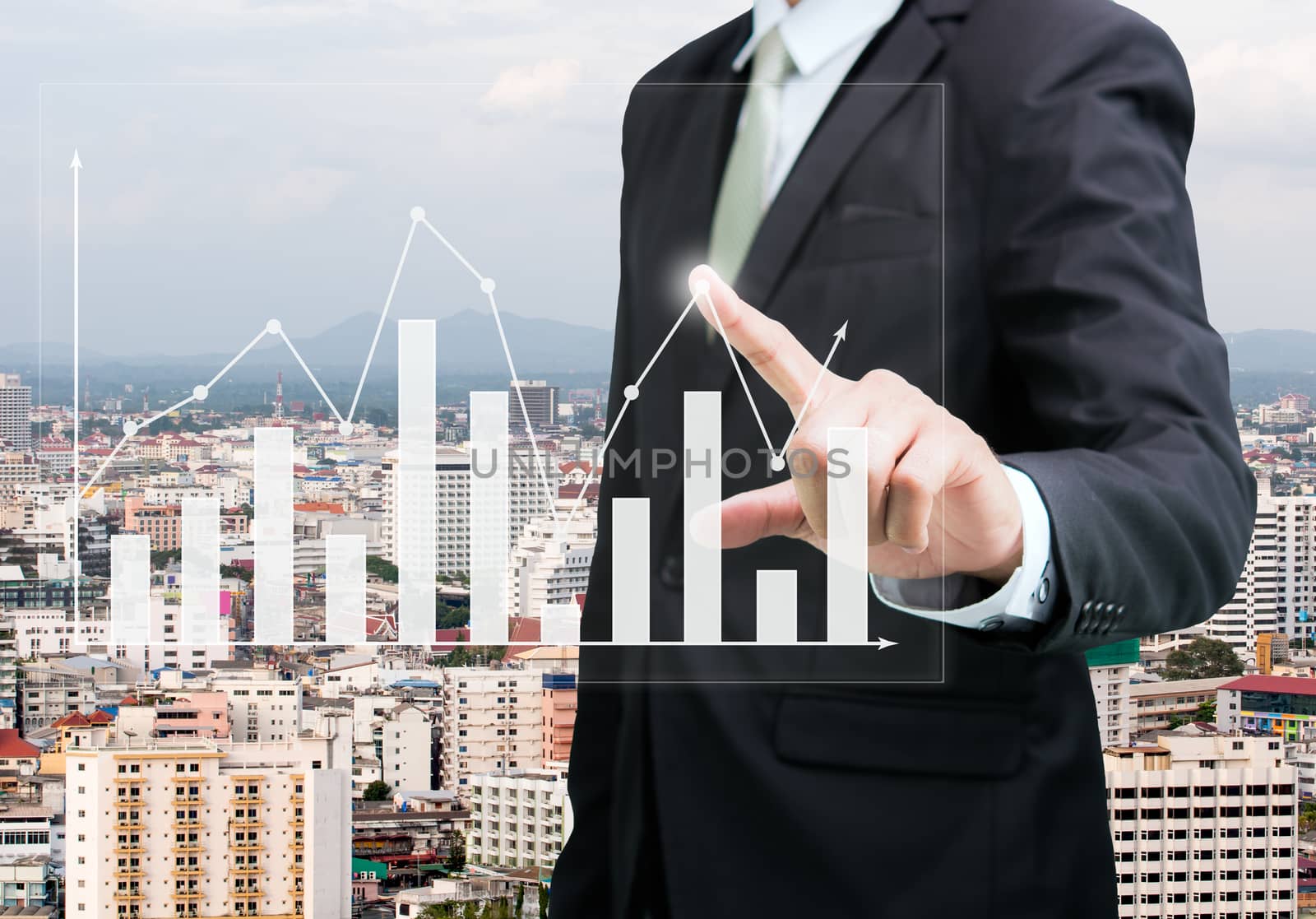 Businessman standing posture hand touch graph finance on City background