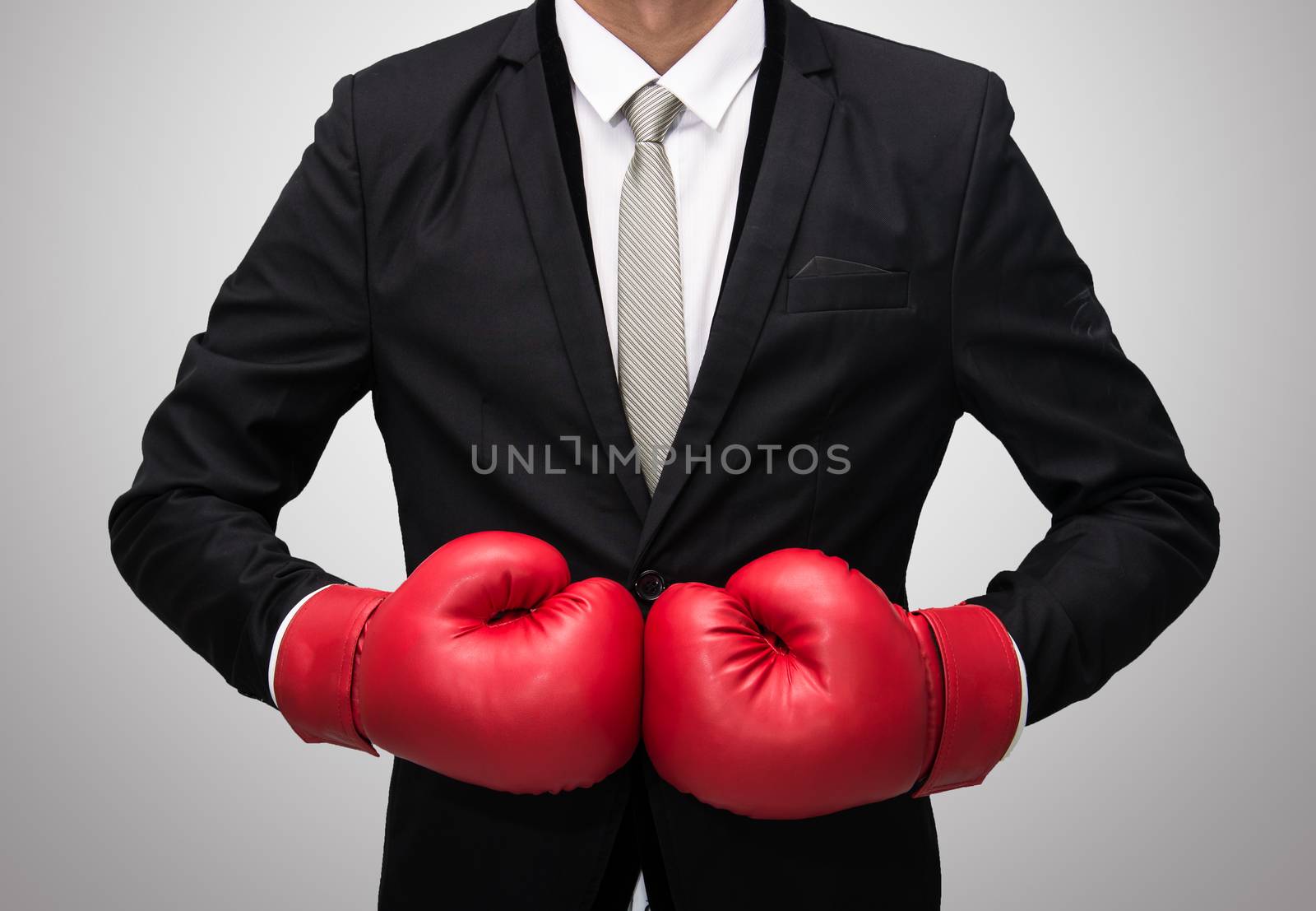 Businessman standing posture in boxing gloves isolated on over gray background