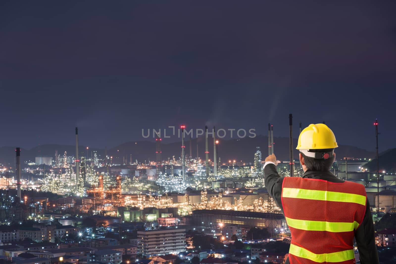 Petrochemical engineering man with white safety helmet standing in oil refinery building structure petrochemical industry