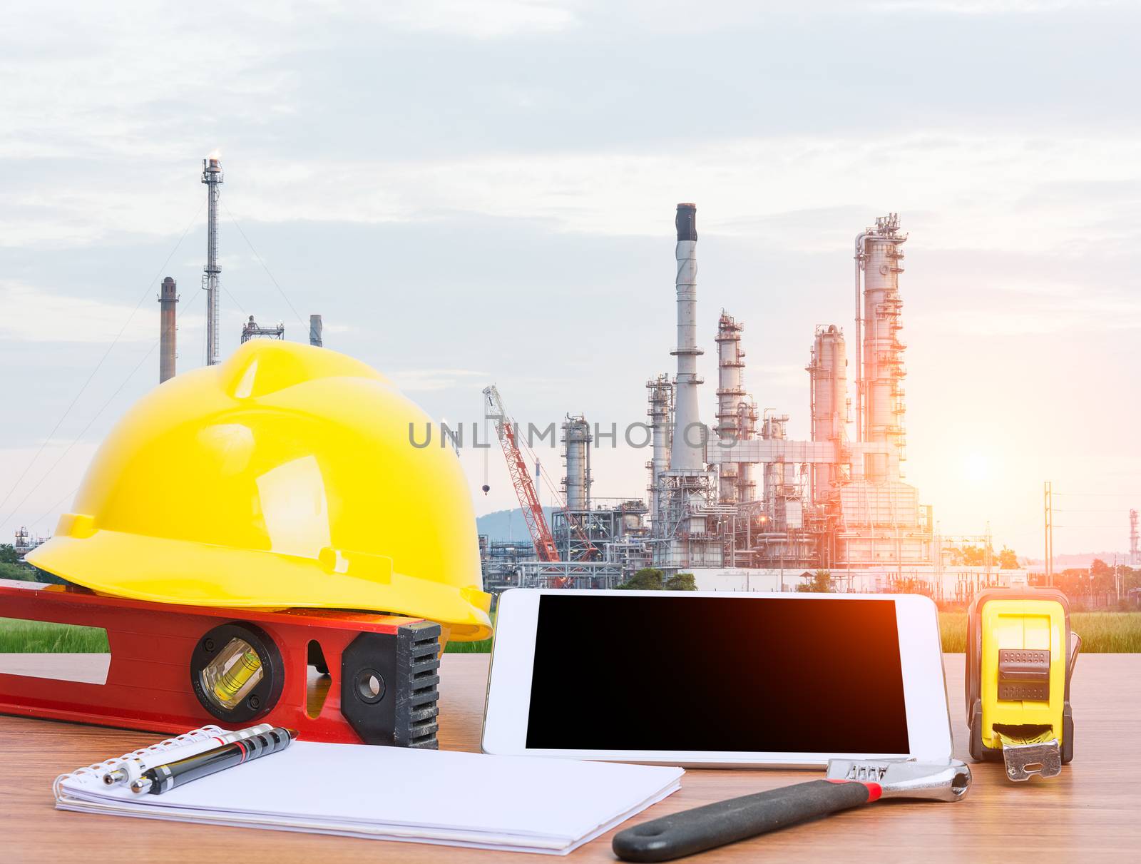 Working table engineer with tablet and tools in oil refinery industry business plant