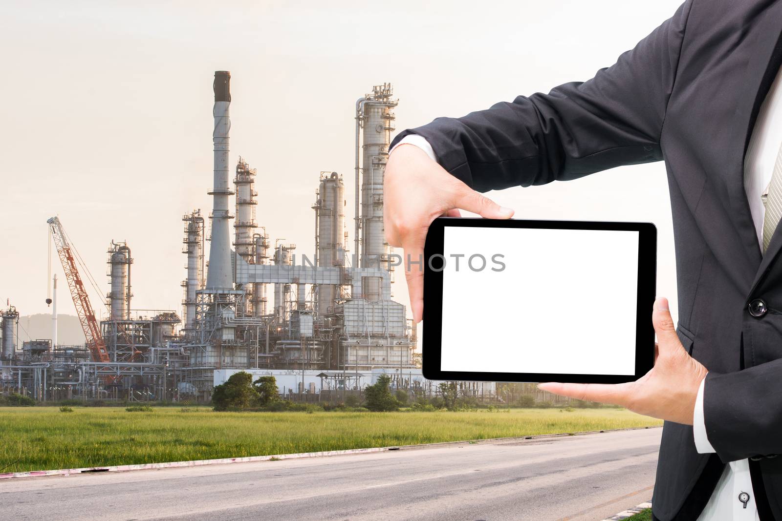 Engineering working hold tablet in front of oil refinery power station