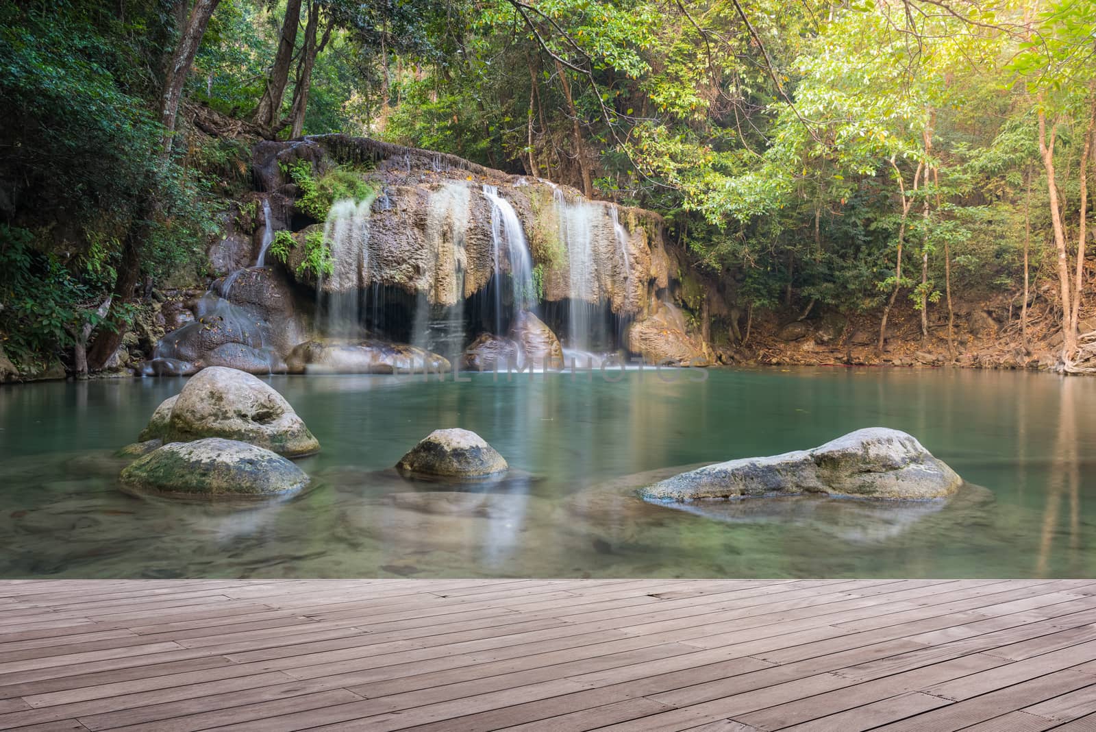 Wooden plank and background with Waterfall in Erawan Park