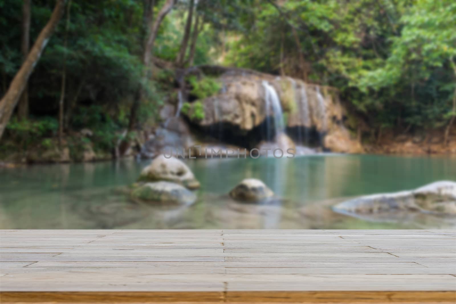 Wooden plank and background with Blur Waterfall Erawan Park