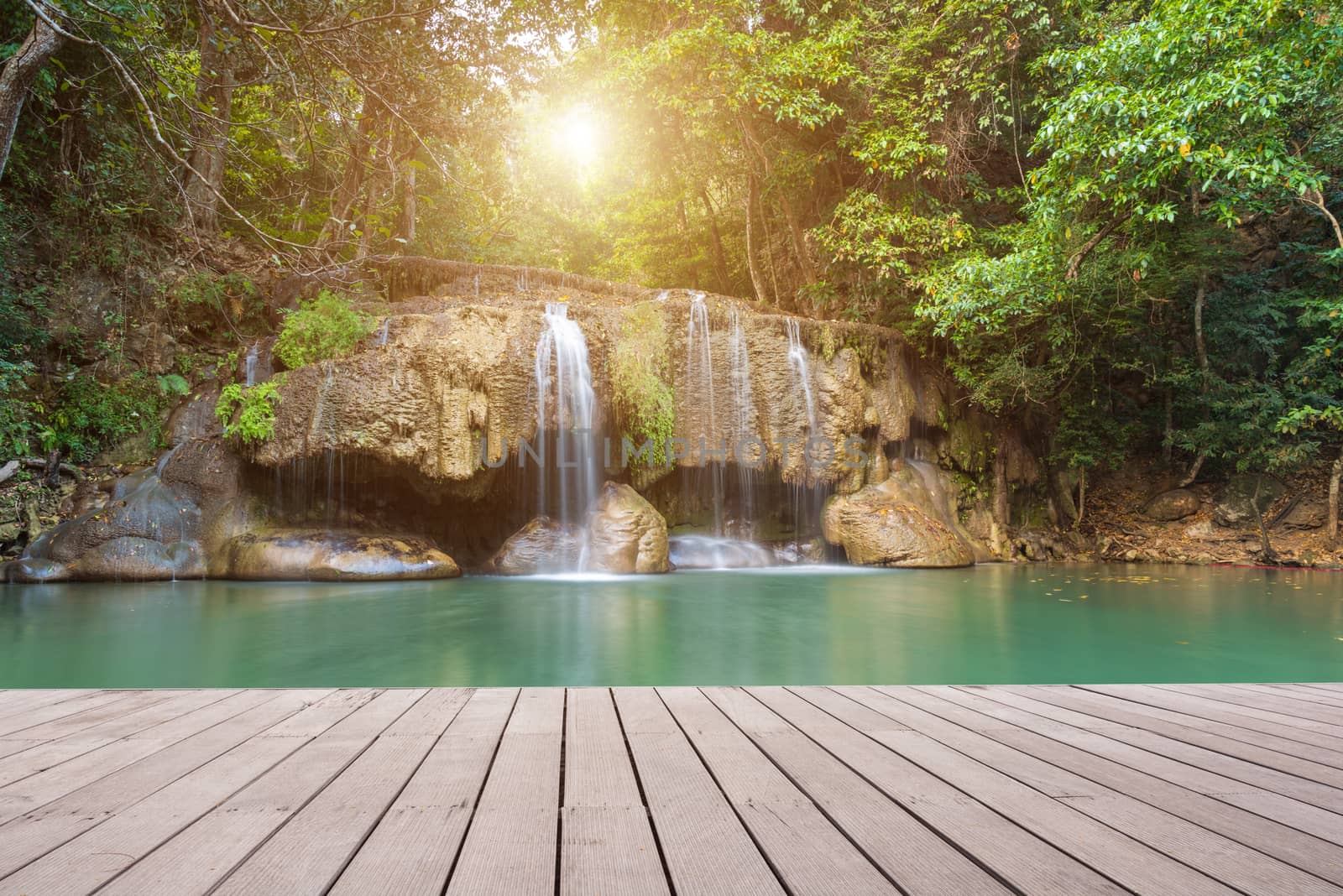 Wooden plank and background with Waterfall in Erawan Park