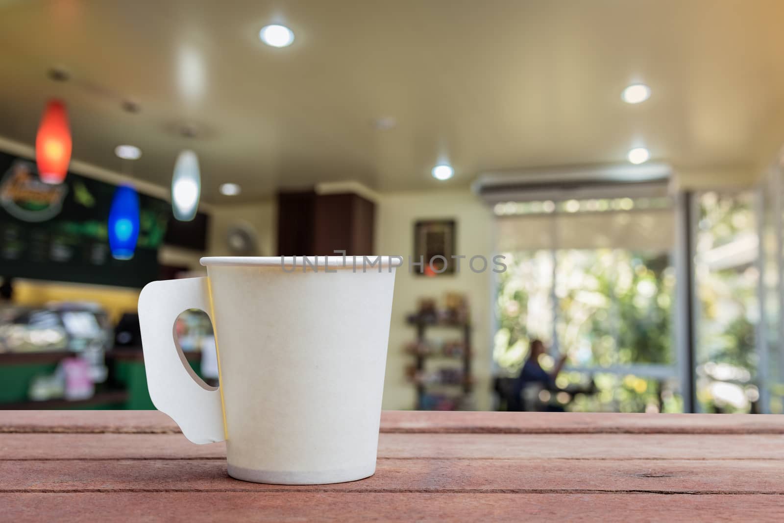 Coffee paper cup in coffee shop blur background