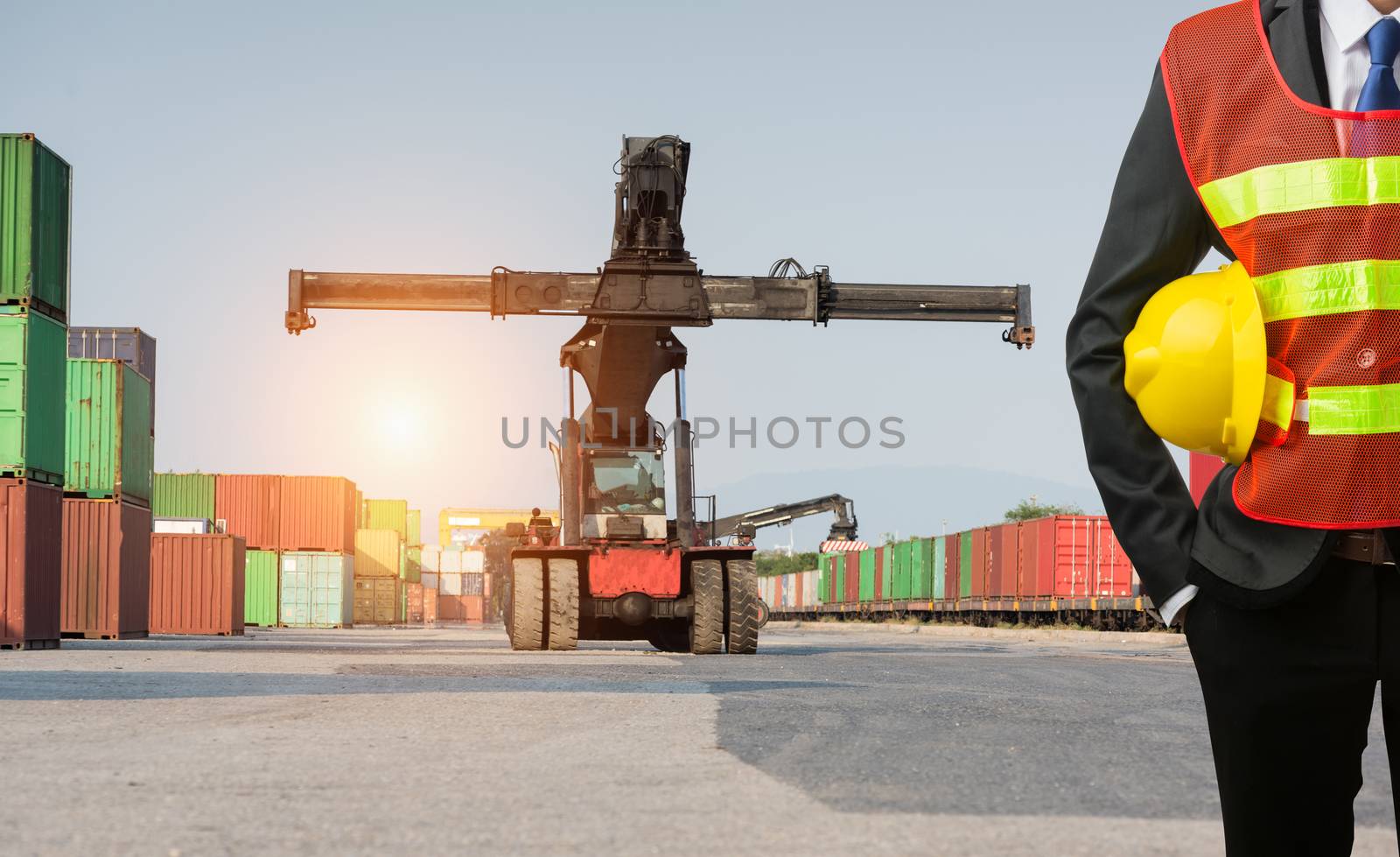 Foreman or working businessman stand on front forklift loading Containers box to Logistic cargo Import Export Background