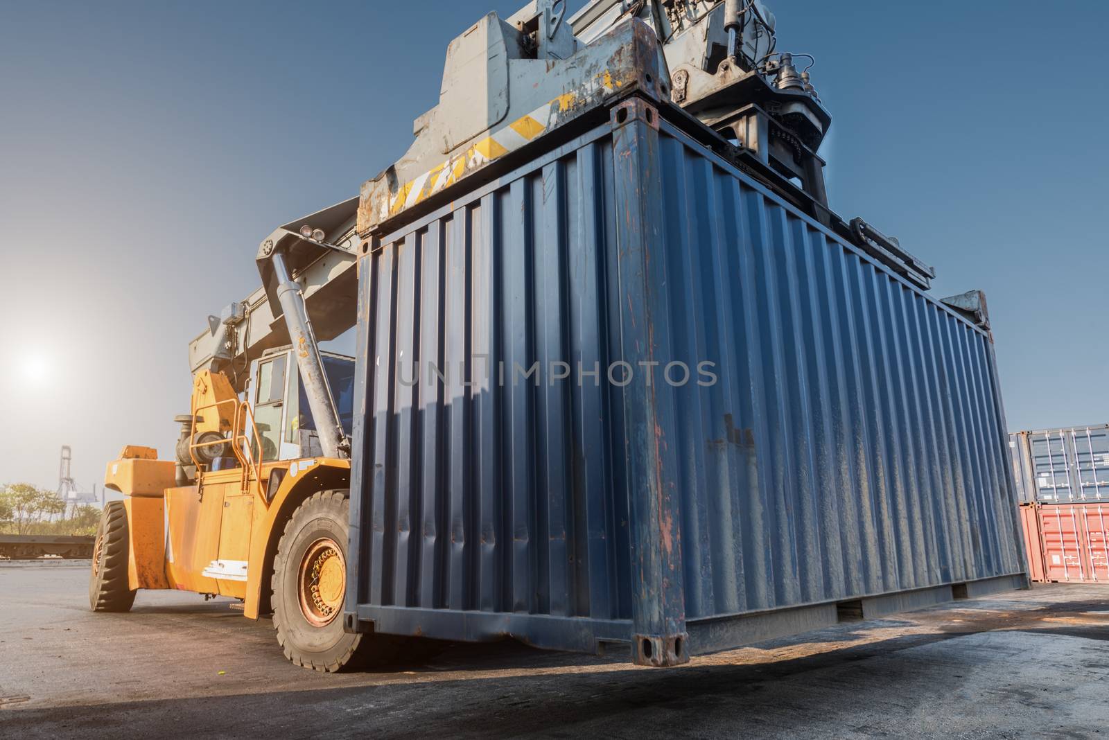 forklift handling container box loading from dock to truck