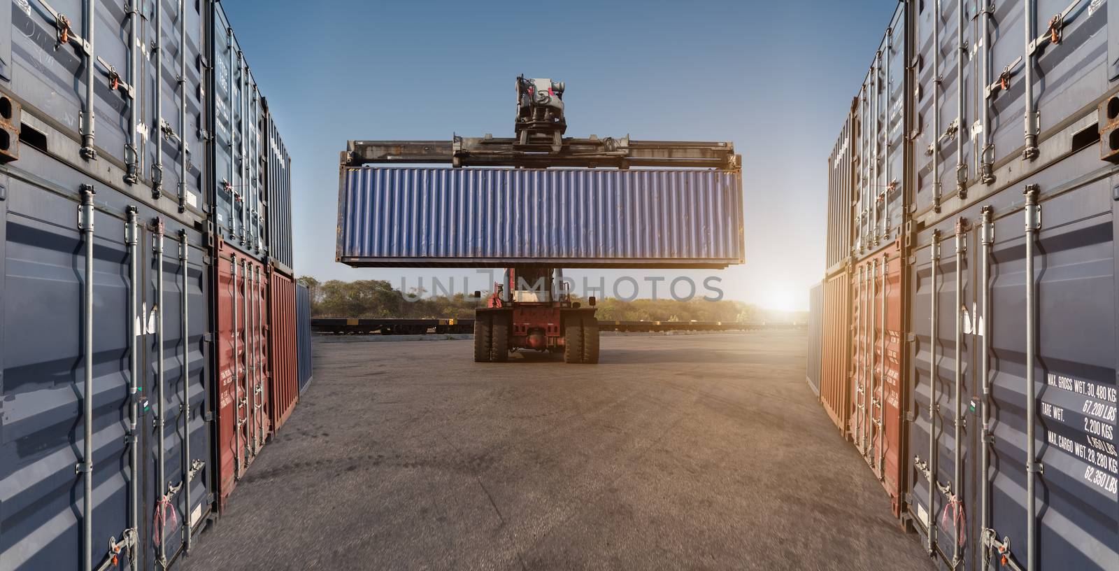 forklift holding handling container box loading for stack at logistic zone