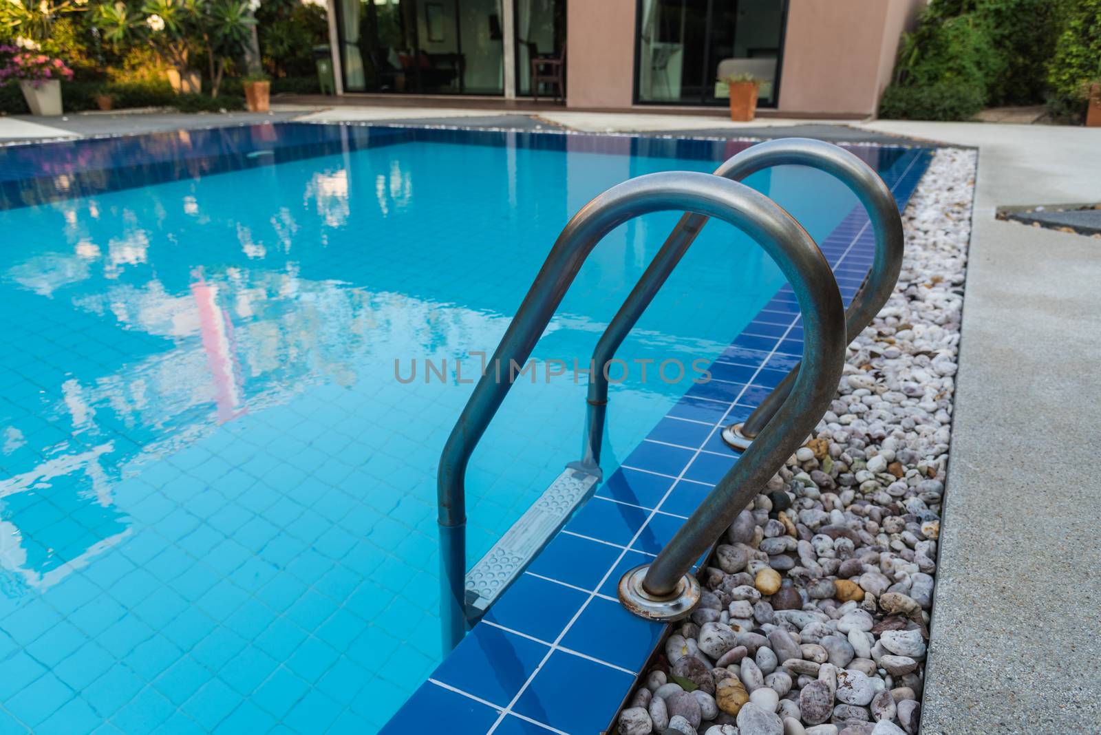 Hotel blue swimming pool with stair for relaxation