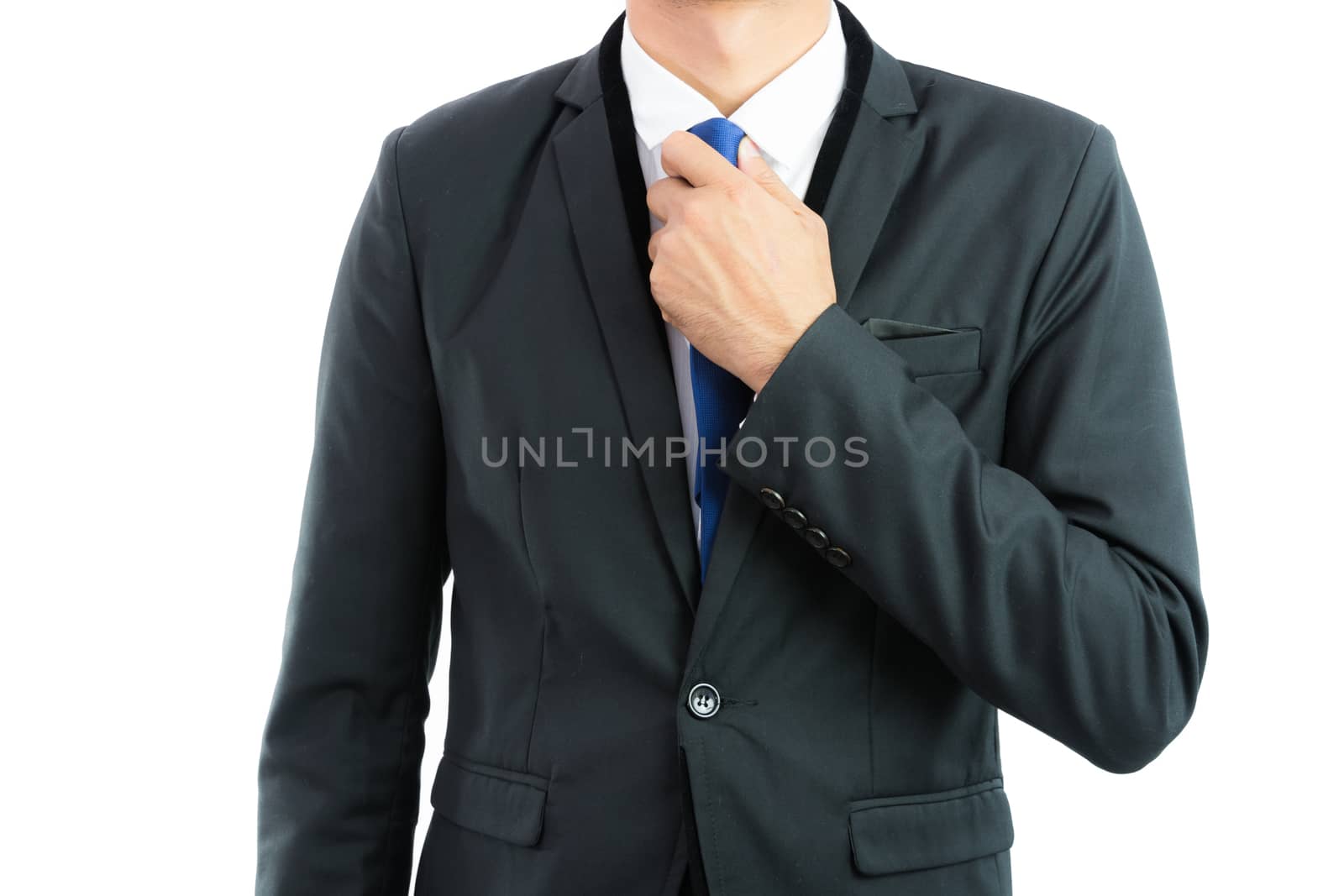 Businessman adjusting necktie isolated on over white background