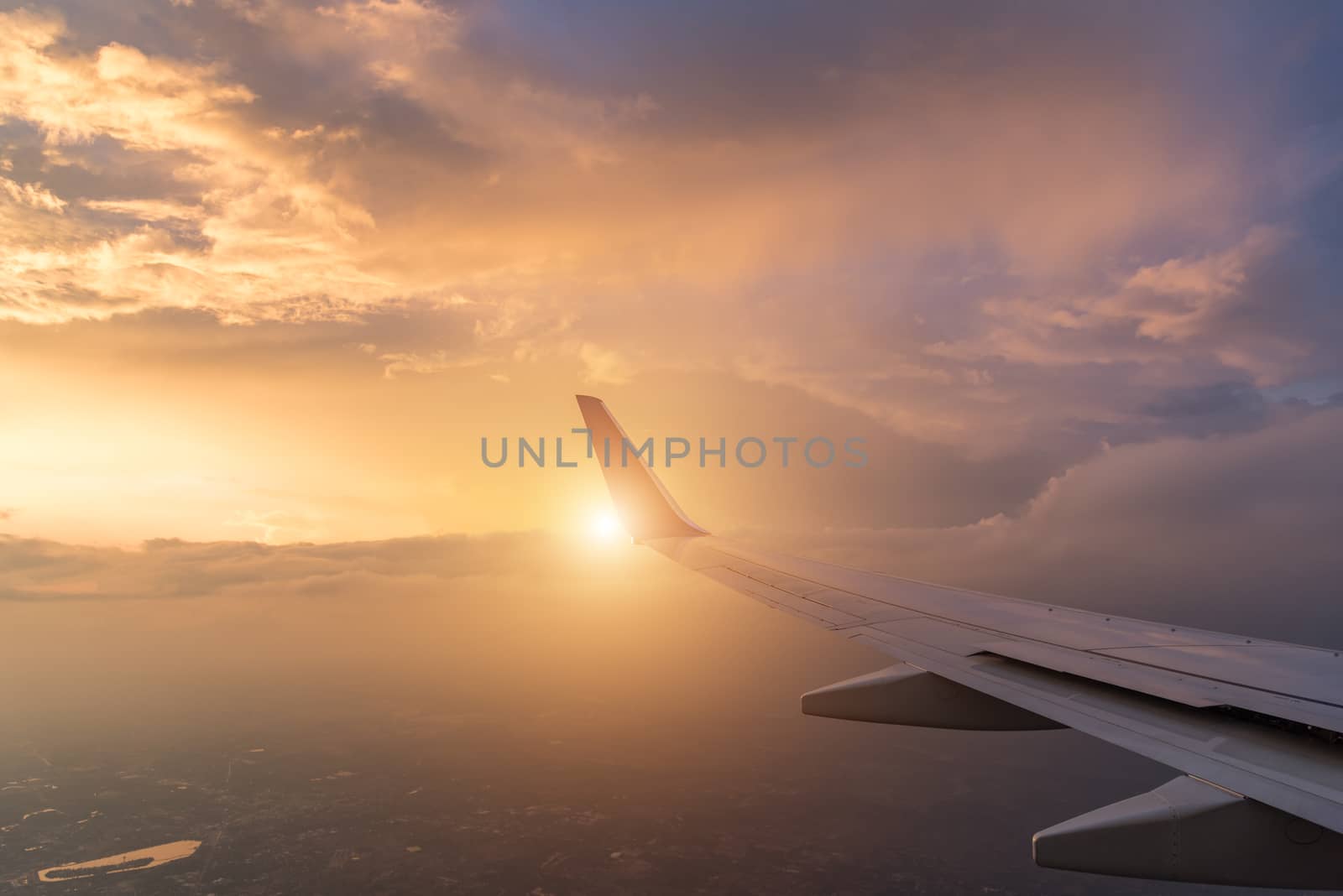 Wing aircraft at cloud sunset view from plane