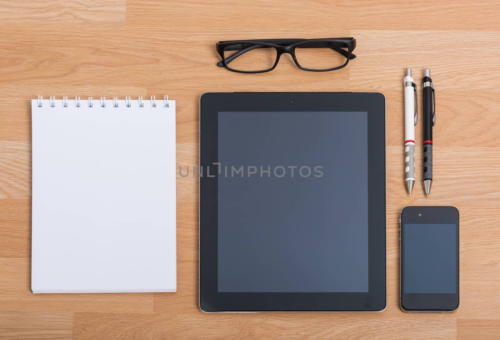 Top view office table with mobile phone, keyboard and mouse on wooden desk