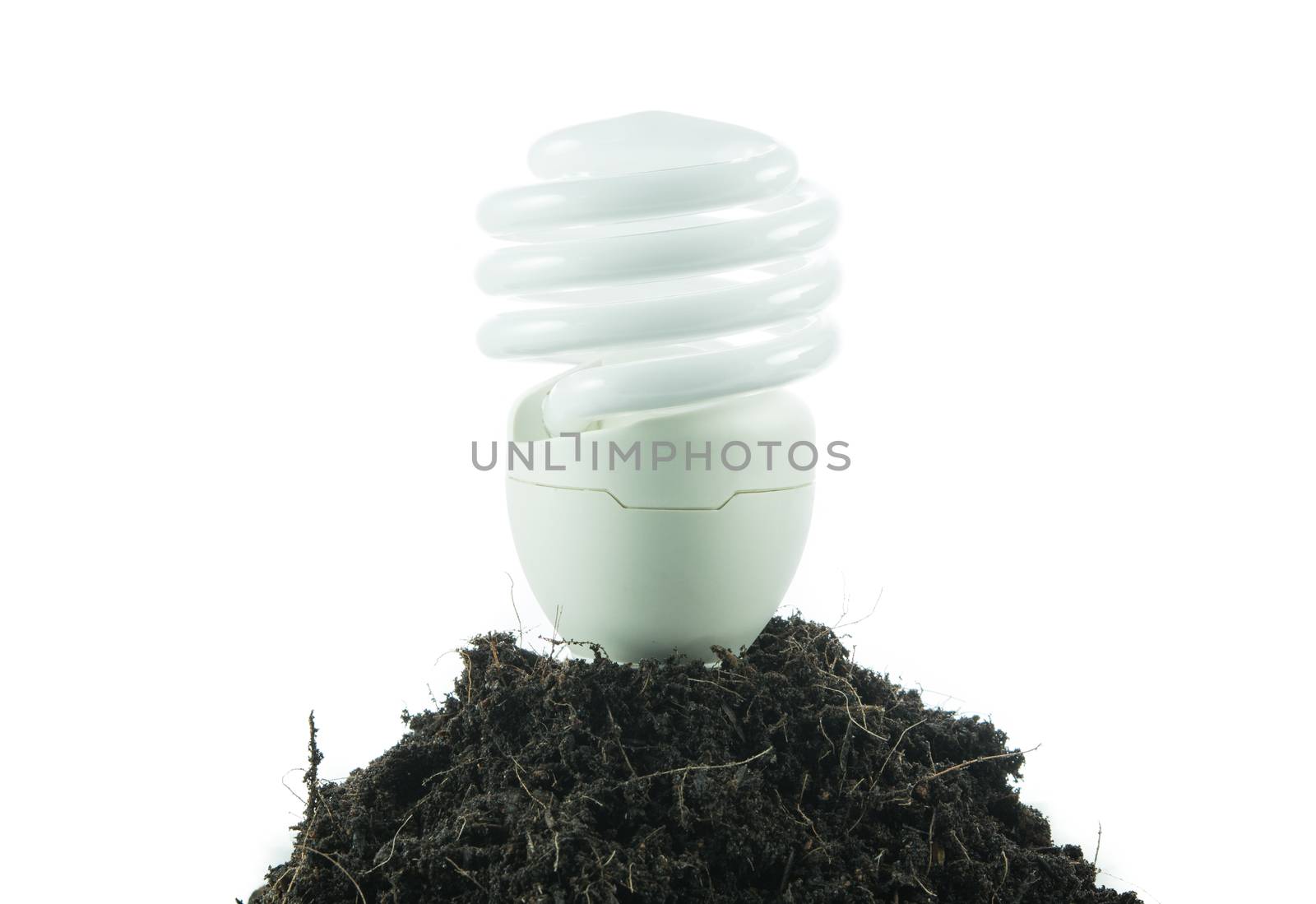 Pile of soil with light bulb green energy concept isolated on over white background