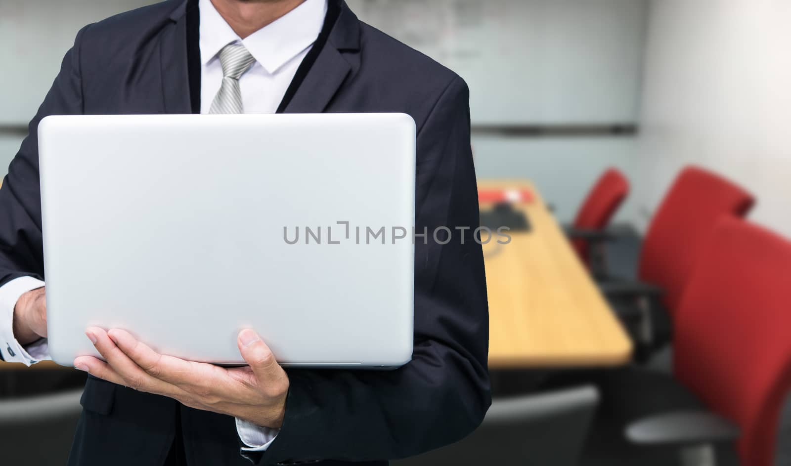 Businessman hold laptop computer in meeting room