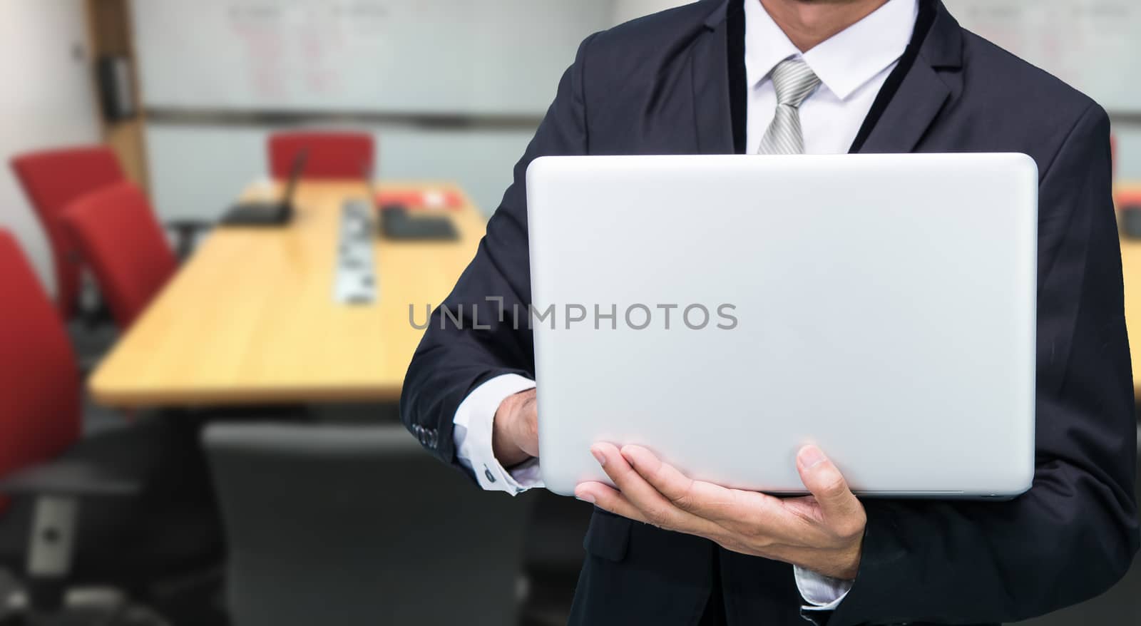 Businessman hold laptop computer in meeting room