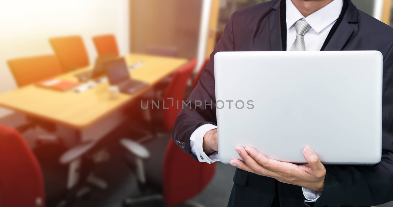 Businessman hold laptop computer in meeting room