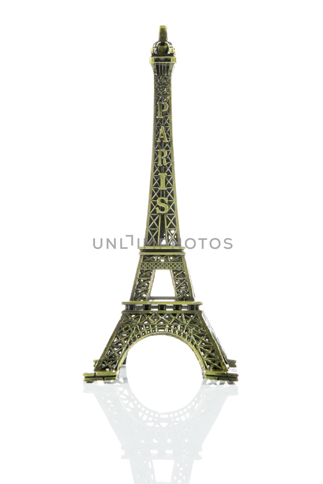 Small Eiffel tower isolated on over white background