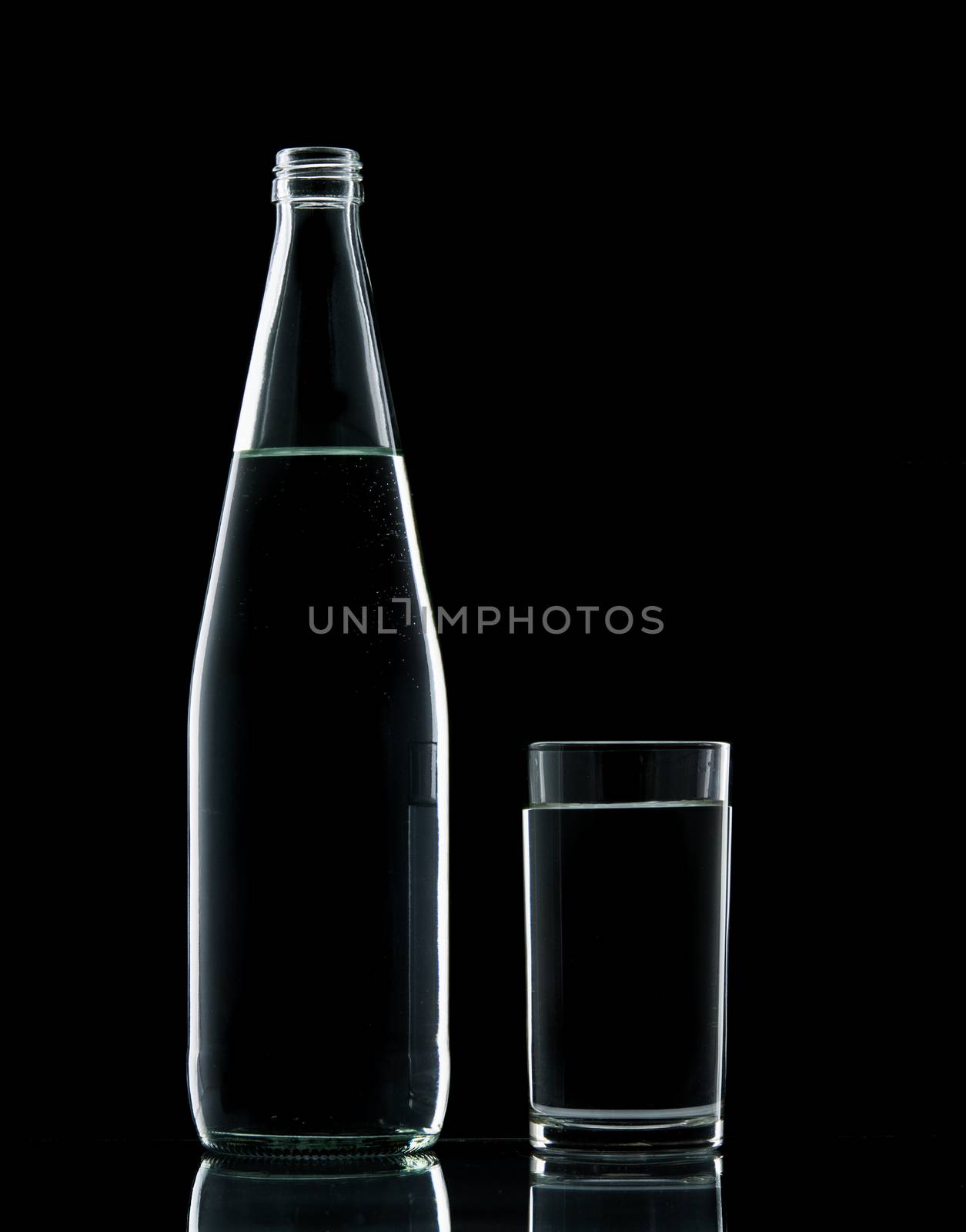 Bottle and Glass water clear isolate on over black background