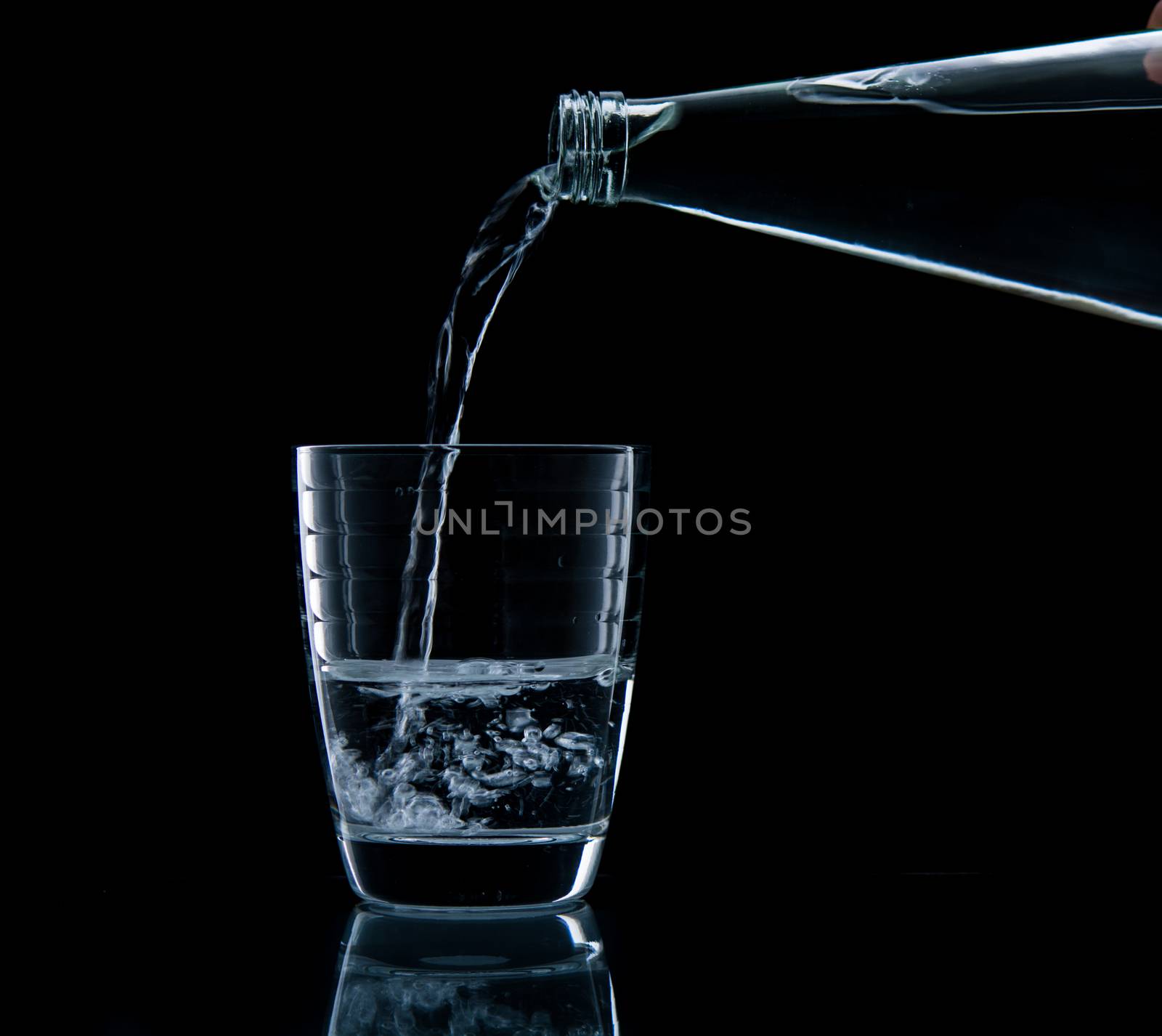 Pouring water on glass by Sorapop